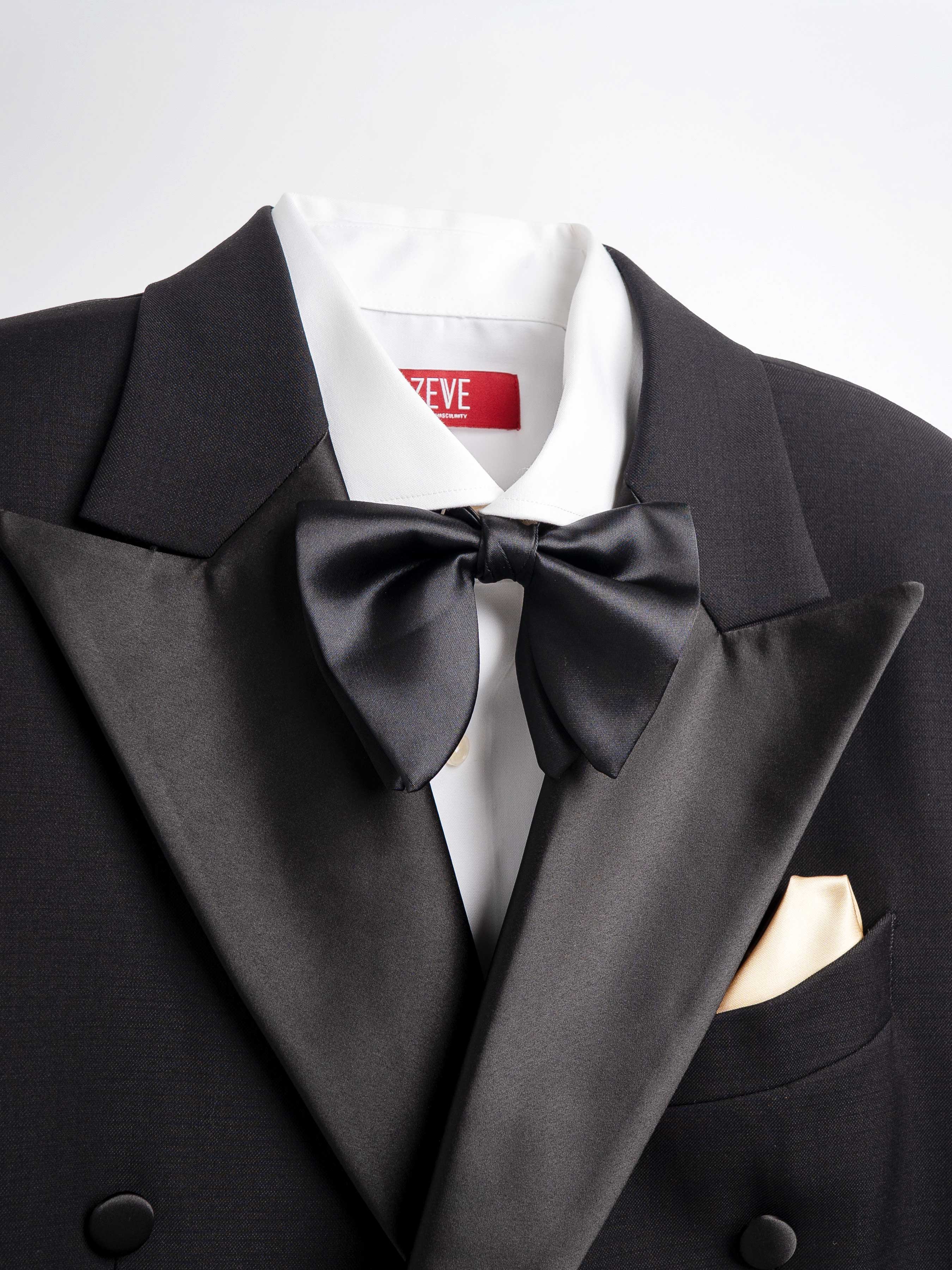 Black tuxedo with satin lapels, bow tie, and gold pocket square, paired with white dress shirt for formal occasions.