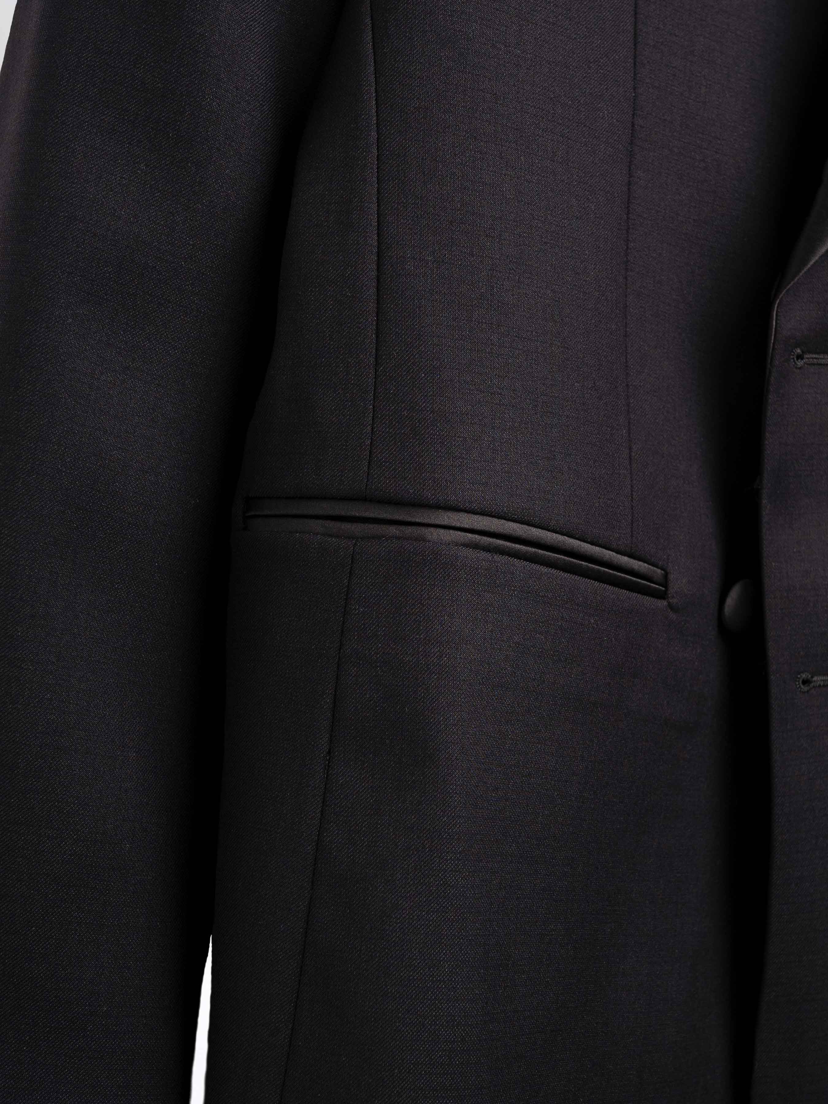 Black men's formal suit jacket with sleek pocket detail and tailored fit