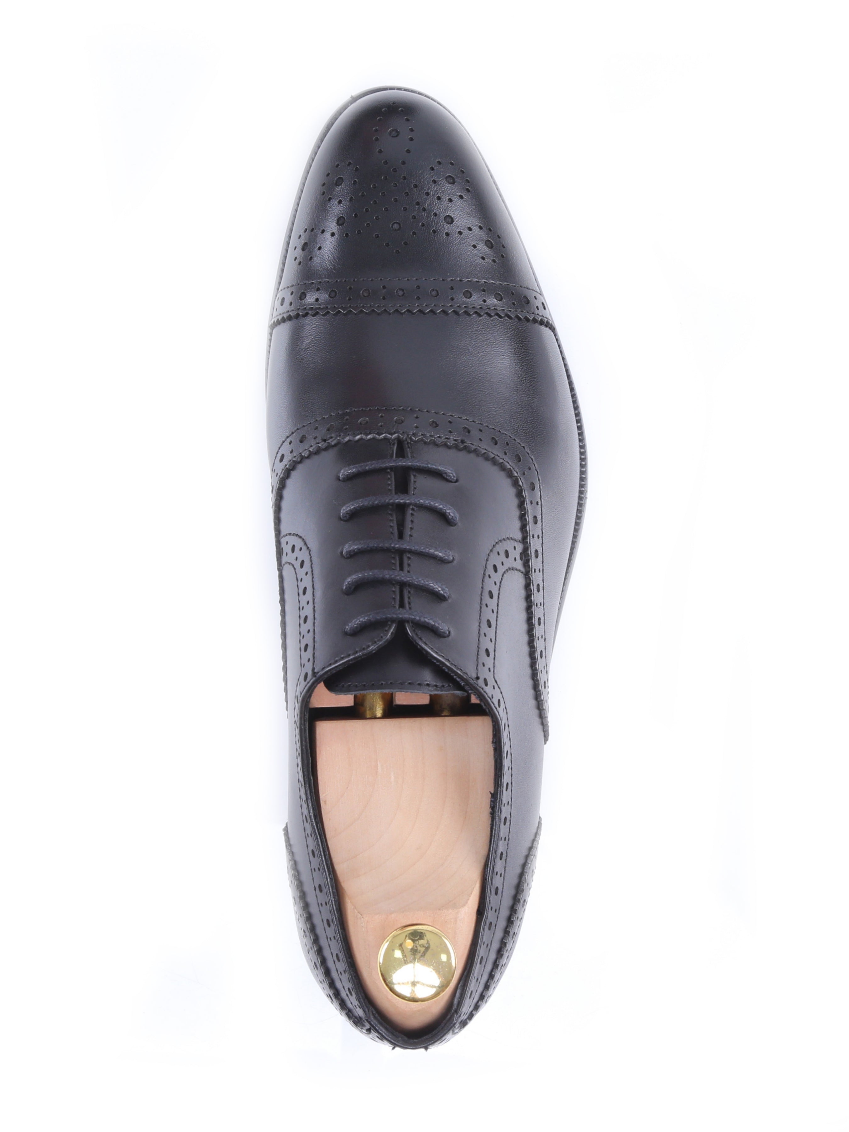Black leather men’s oxford dress shoe with brogue detail, shown from above on white background