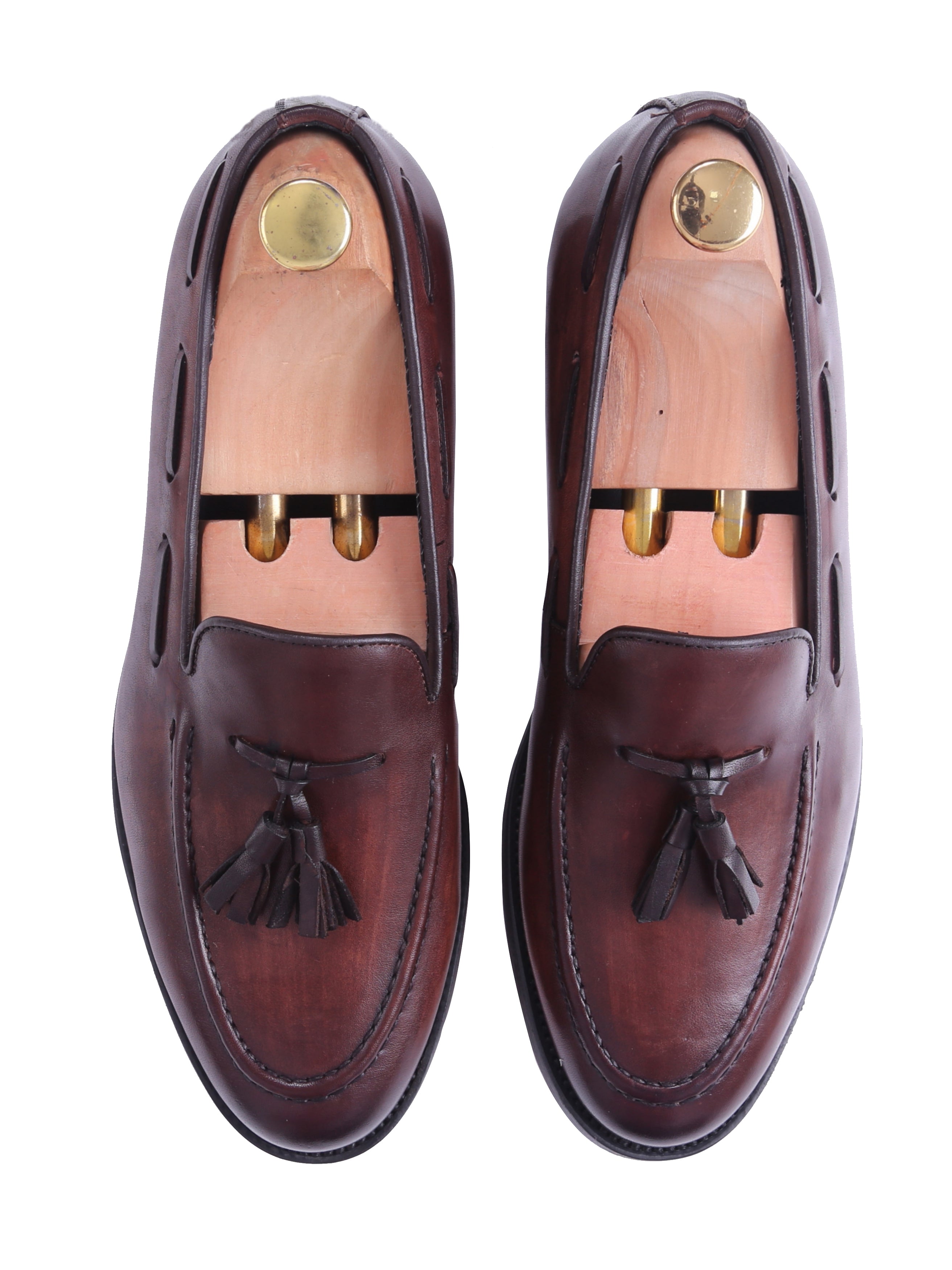 Men's brown leather tassel loafers with wooden shoe trees, formal footwear on white background