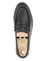 Black leather loafer with gold hardware and branded insole, top view
