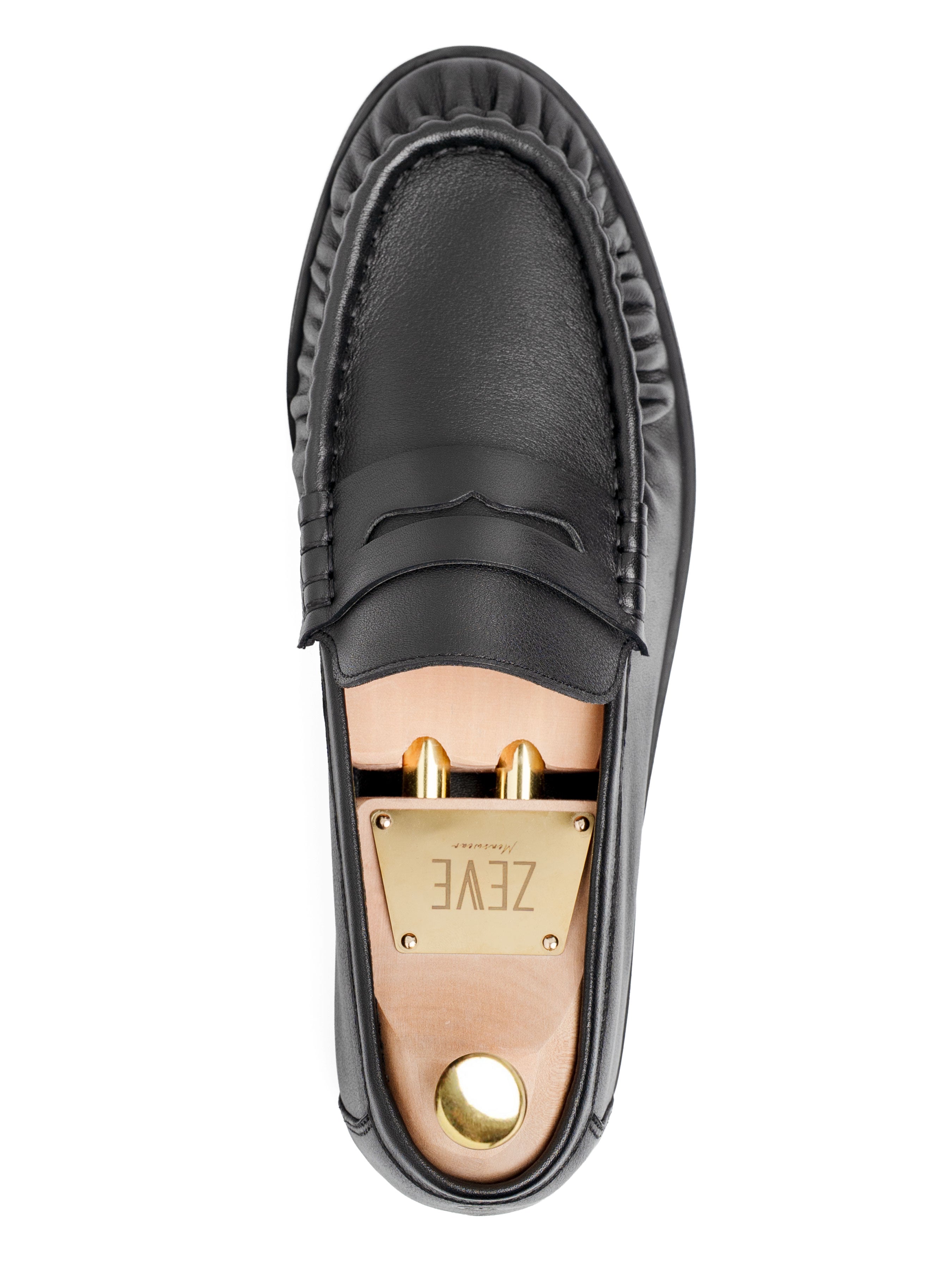 Black leather loafer with gold hardware and branded insole, top view