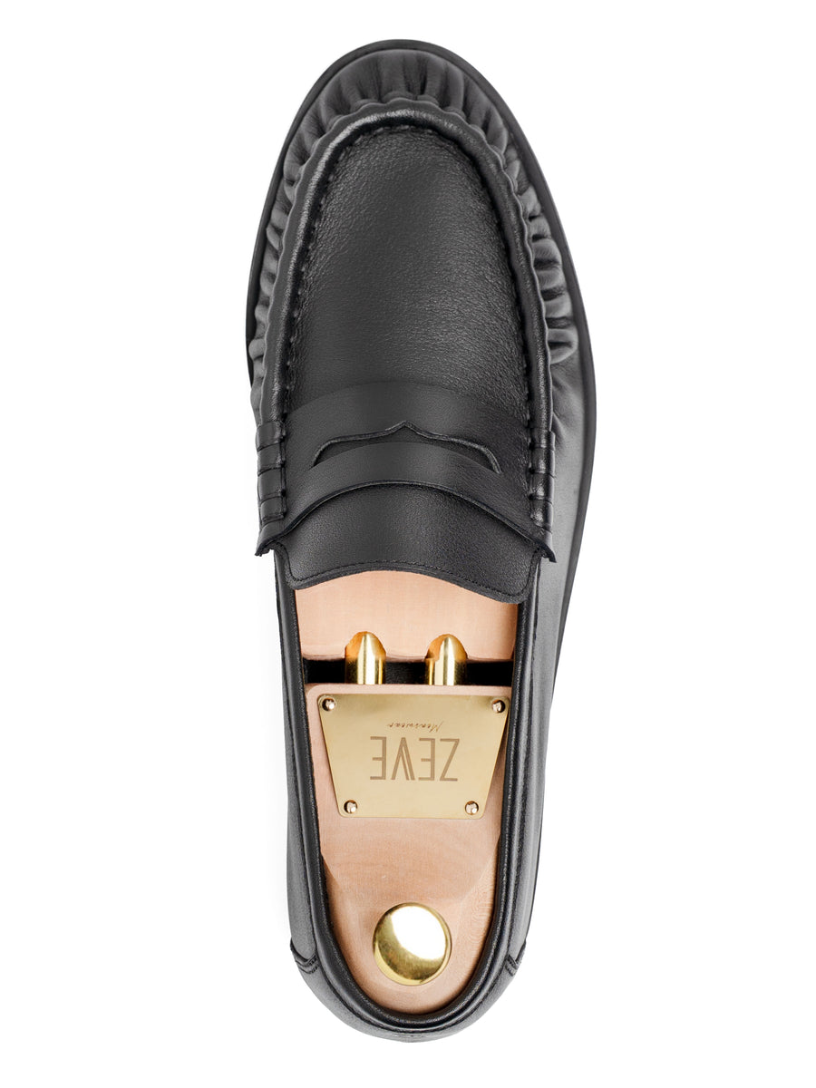 Black leather loafer with gold hardware and branded insole, top view