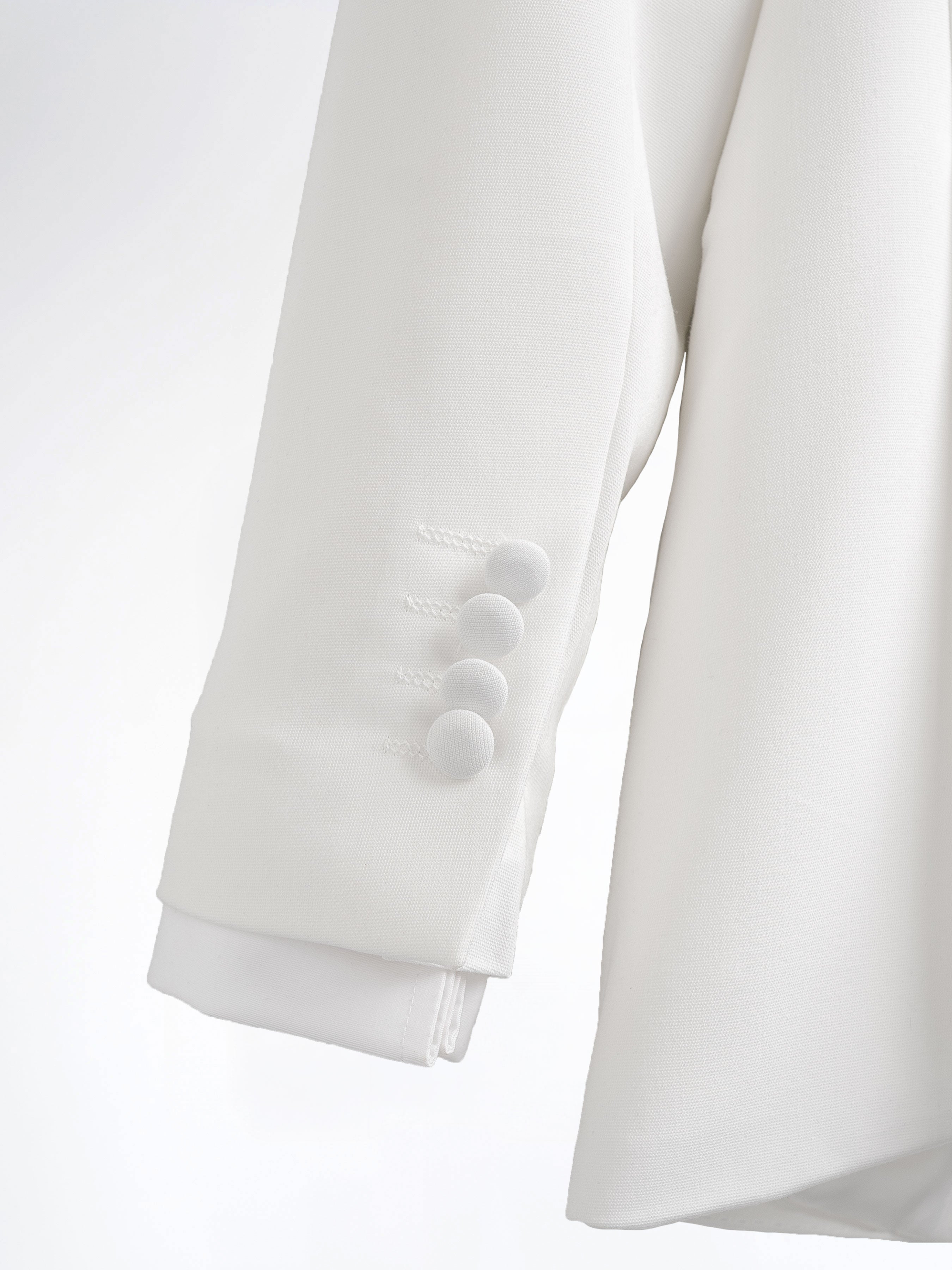 White men's suit jacket sleeve with four buttons, formal wear detail