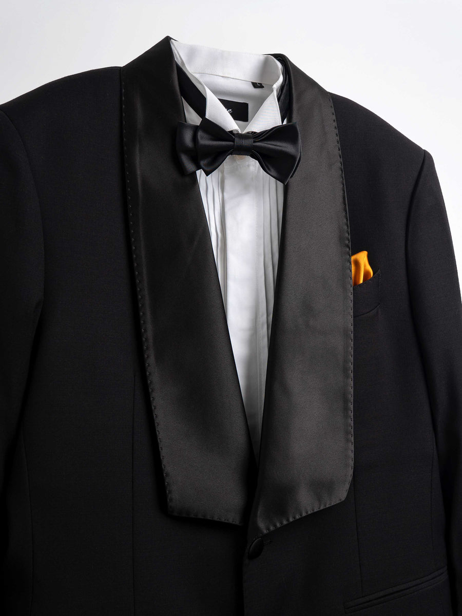 Black tuxedo with satin lapels, bow tie, white dress shirt, and orange pocket square for formal events