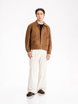 Men's brown suede jacket with white trousers and loafers, stylish casual outfit