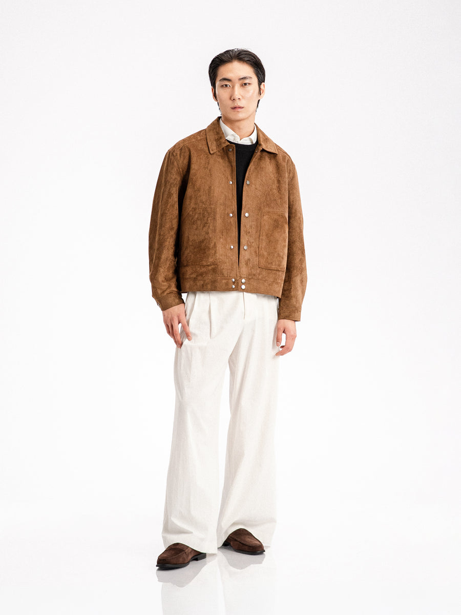 Men's brown suede jacket with white trousers and loafers, stylish casual outfit