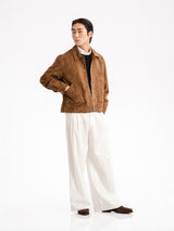 Men's brown suede jacket with white trousers and loafers, stylish casual outfit
