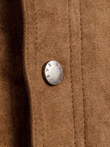 Close-up of a brown wool coat with a branded metal button, showcasing textured fabric and tailored stitching.