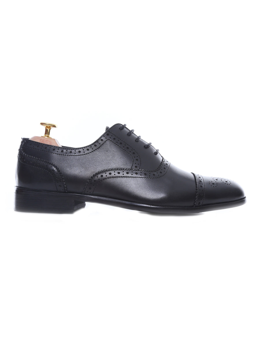Men’s black leather brogue oxford shoe with perforated detailing on a white background