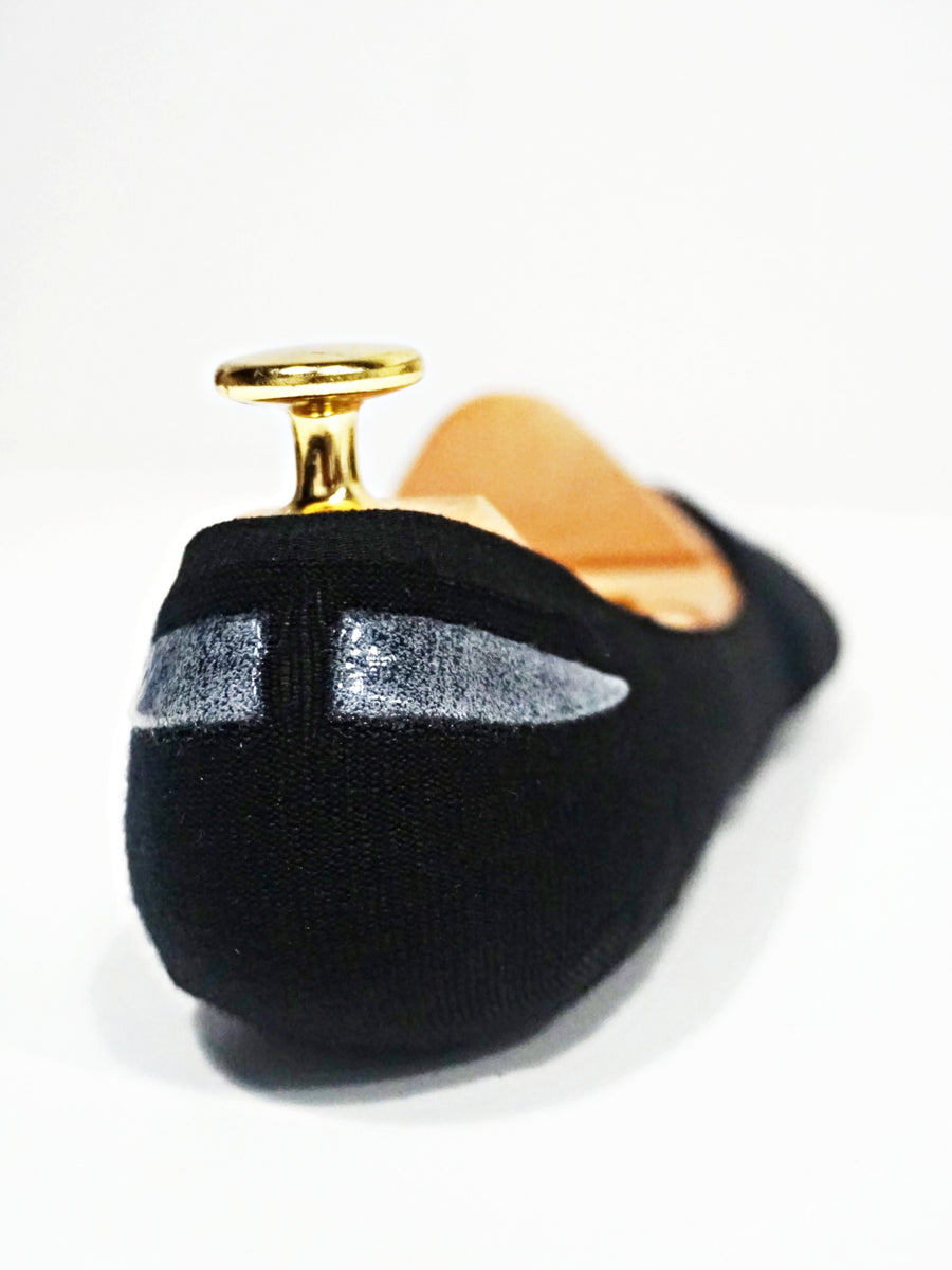 Black men's loafer with silver accents and gold heel detail